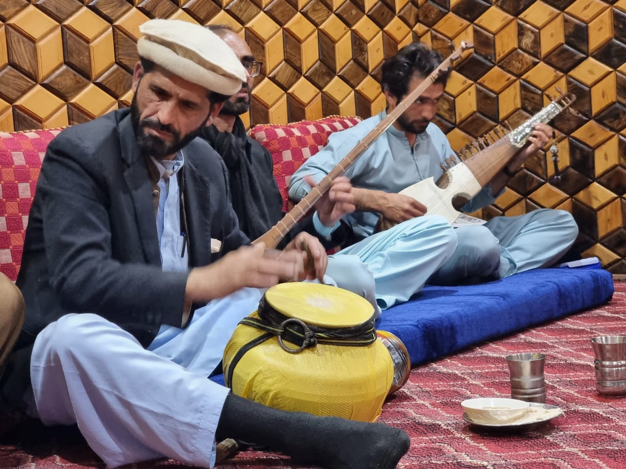 Torwali singer-poets Haleem Khan Noorani (left) plays the Bhden and Sitar, and Zahoor Ahmad Torwali (right) plays the rabab.